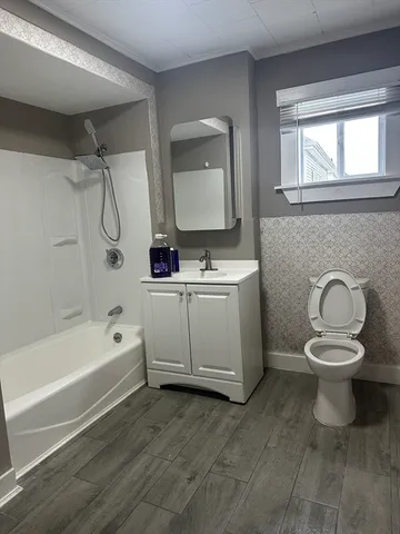 a bathroom with a sink toilet and shower