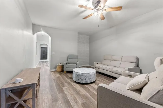 a living room with furniture and a chandelier