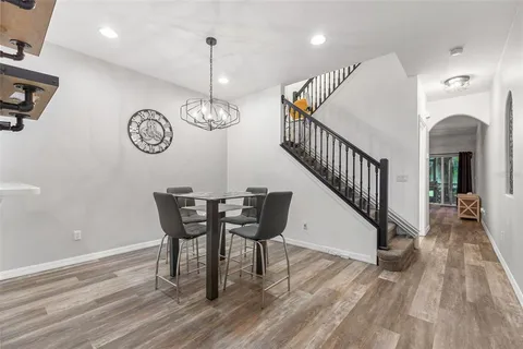 a view of a dining room with furniture wooden floor and a chandelier