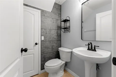 a bathroom with a toilet sink and shower
