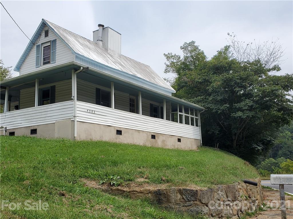 4580 Little Pine Road Marshall, NC 28753 - Photo 11 of 39 a large white house with a large garden