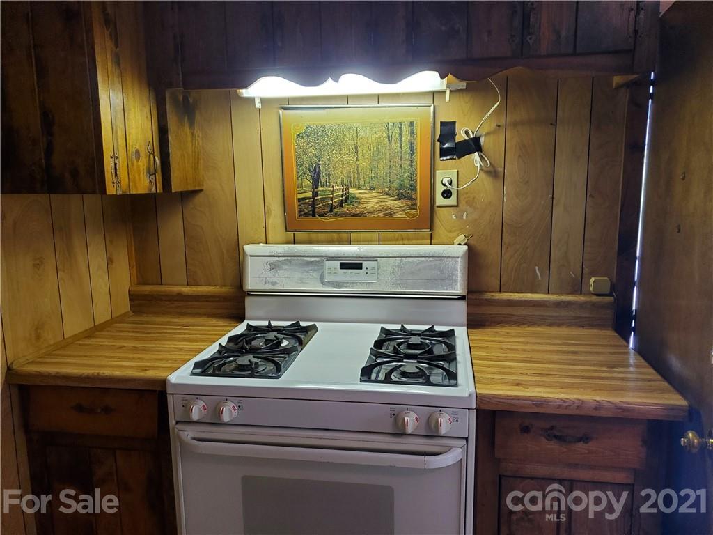4580 Little Pine Road Marshall, NC 28753 - Photo 13 of 39 a kitchen with a stove and a cabinet