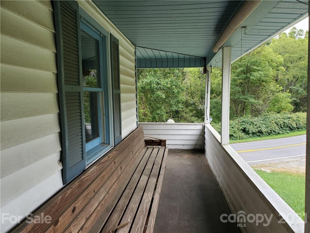 4580 Little Pine Road Marshall, NC 28753 - Photo 22 of 39 a view of a balcony with chairs and wooden floor