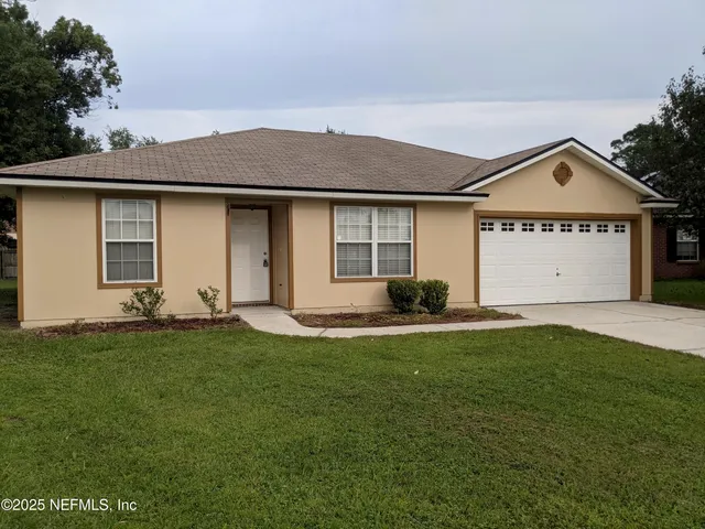 a view of a house with a yard