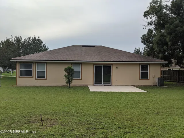 a front view of a house with a garden and yard