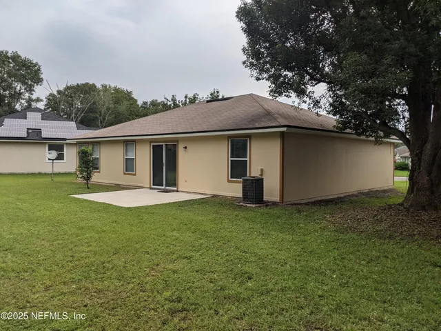 a view of a house with a backyard