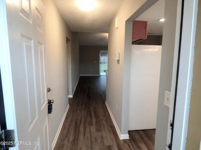 a view of hallway with wooden floor
