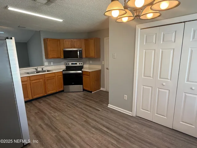 a kitchen with stainless steel appliances granite countertop a stove and a refrigerator