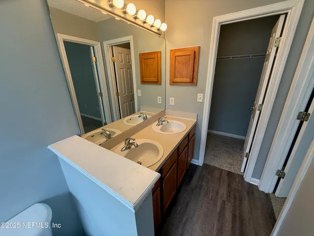 a bathroom with a sink a toilet and a mirror