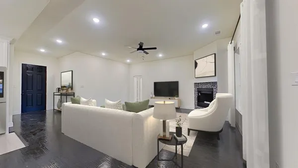 a living room with fireplace furniture and a wooden floor
