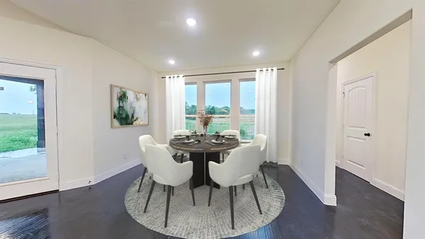 a kitchen with stainless steel appliances granite countertop a sink a stove a refrigerator and white cabinets