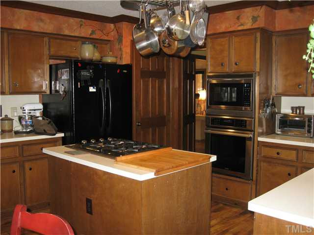 8609 Harbor Drive Raleigh, NC 27615 - Photo 14 of 25 Great chef's kitchen....lots of cabinets, two pantries...island and pot rack.