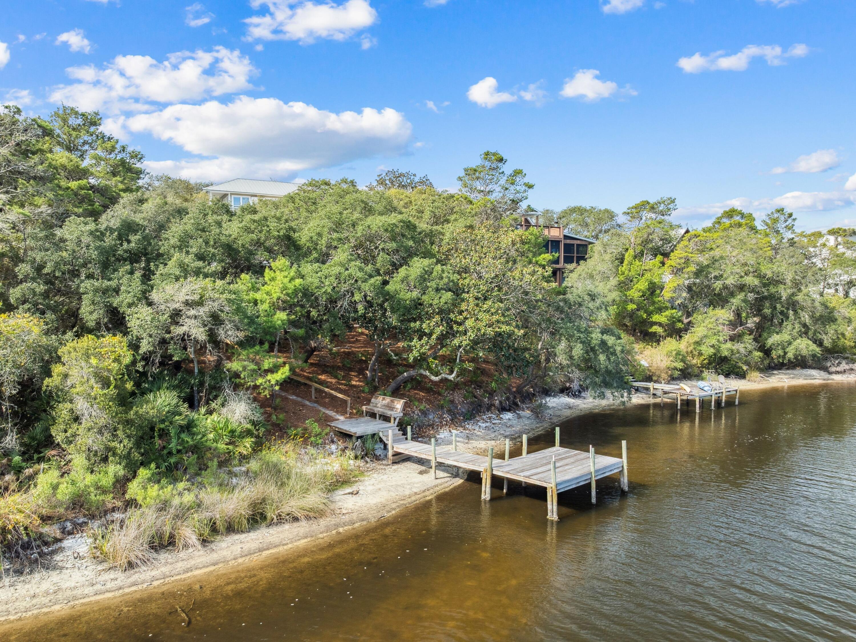 219 Blue Lake Road Santa Rosa Beach, FL 32459 - Photo 10 of 11 a view of a lake with lawn chairs