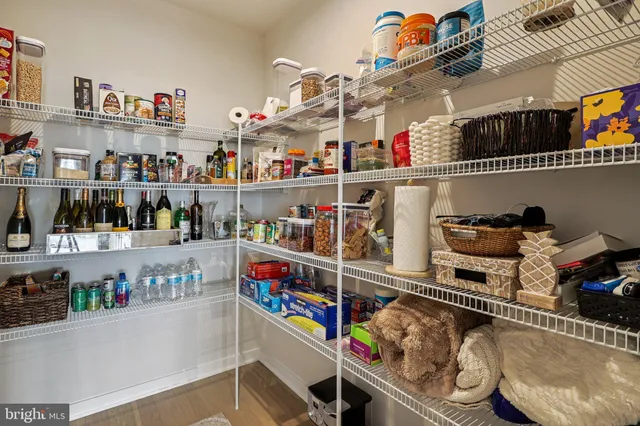 a living room with dining room and chandelier
