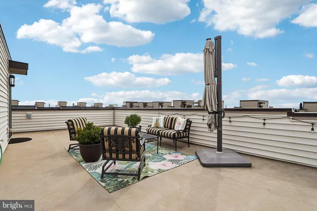 a dining room with wooden floor a chandelier a glass table and chairs