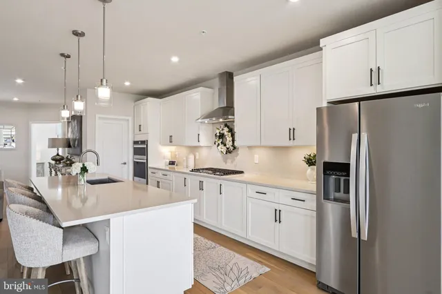 a kitchen with white cabinets stainless steel appliances and sink