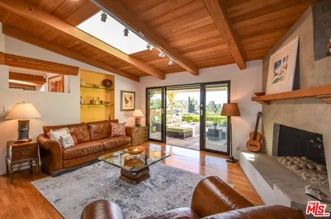 a living room with furniture a fireplace and a table