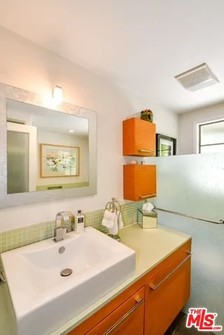 a bathroom with a sink mirror and vanity