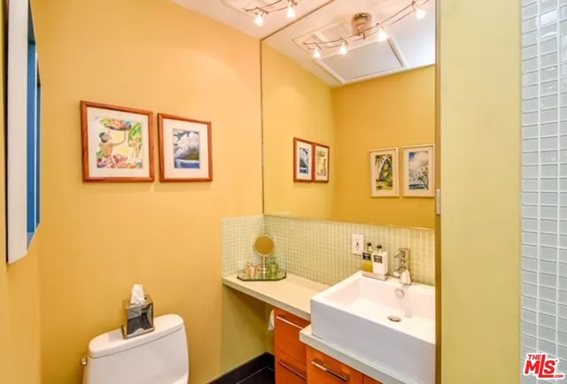 a bathroom with a sink mirror and vanity