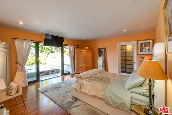 a bedroom with a bed and glass window