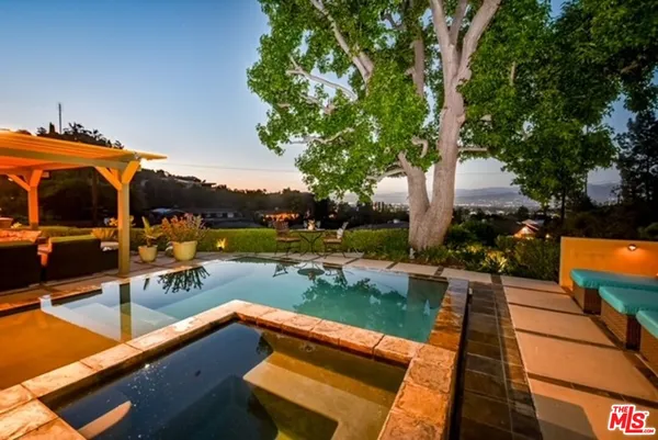 a view of swimming pool with lounge chairs