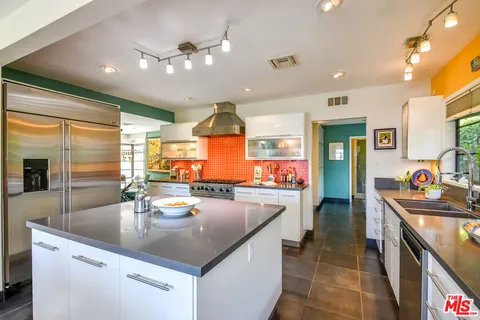 a kitchen with sink a stove and cabinets