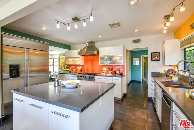 a kitchen with sink a stove and cabinets