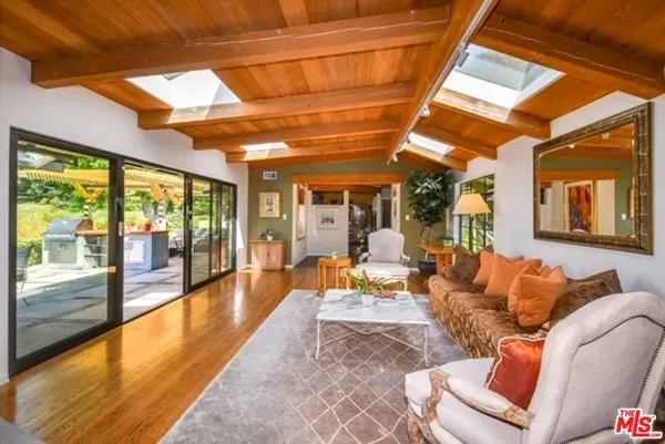 a outdoor space with patio the couches and dining table with a large window