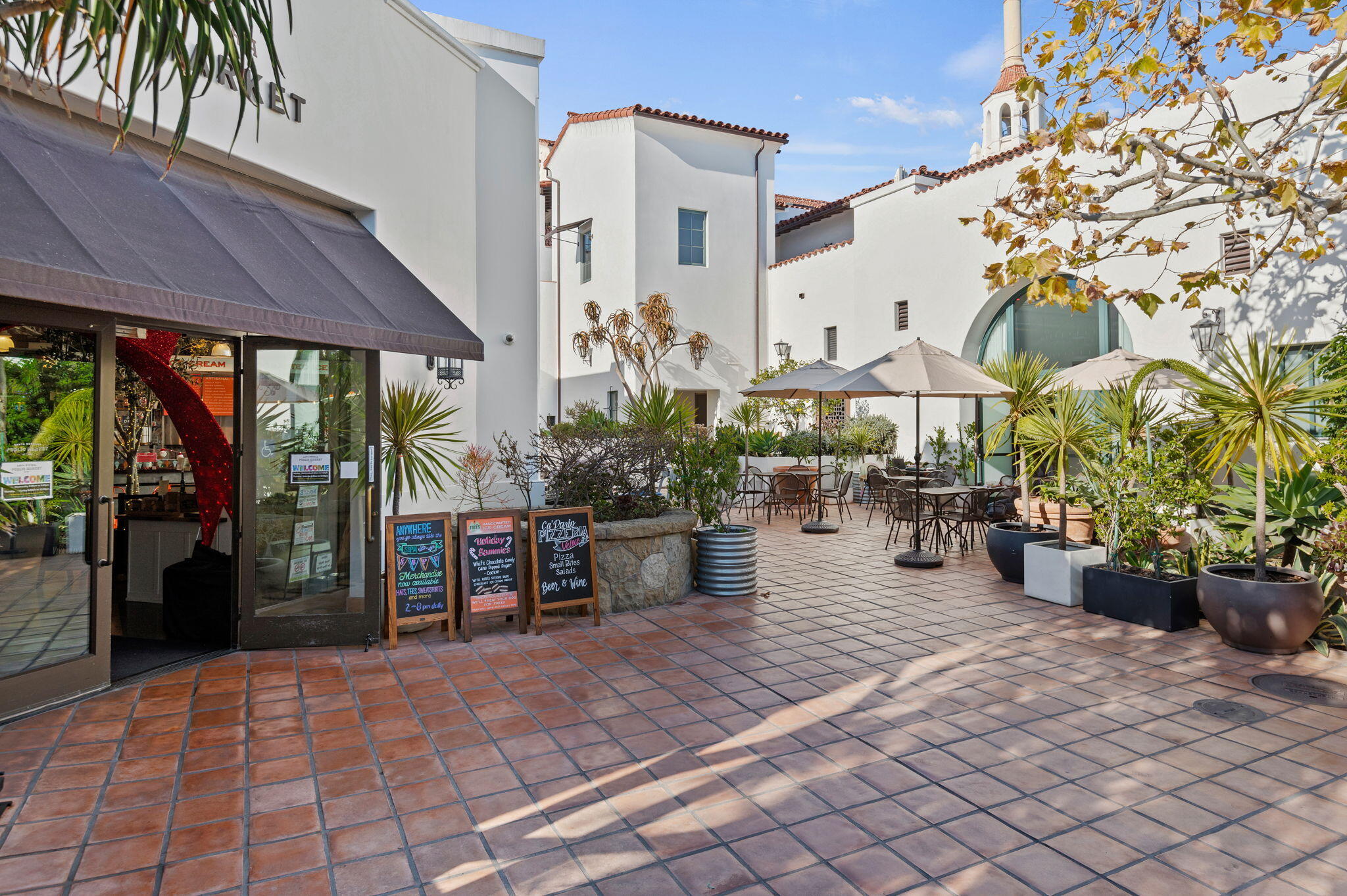 18 West Victoria Street, Unit 303 Santa Barbara, CA 93101 - Photo 26 of 42 a view of a patio with dining table and chairs under an umbrella
