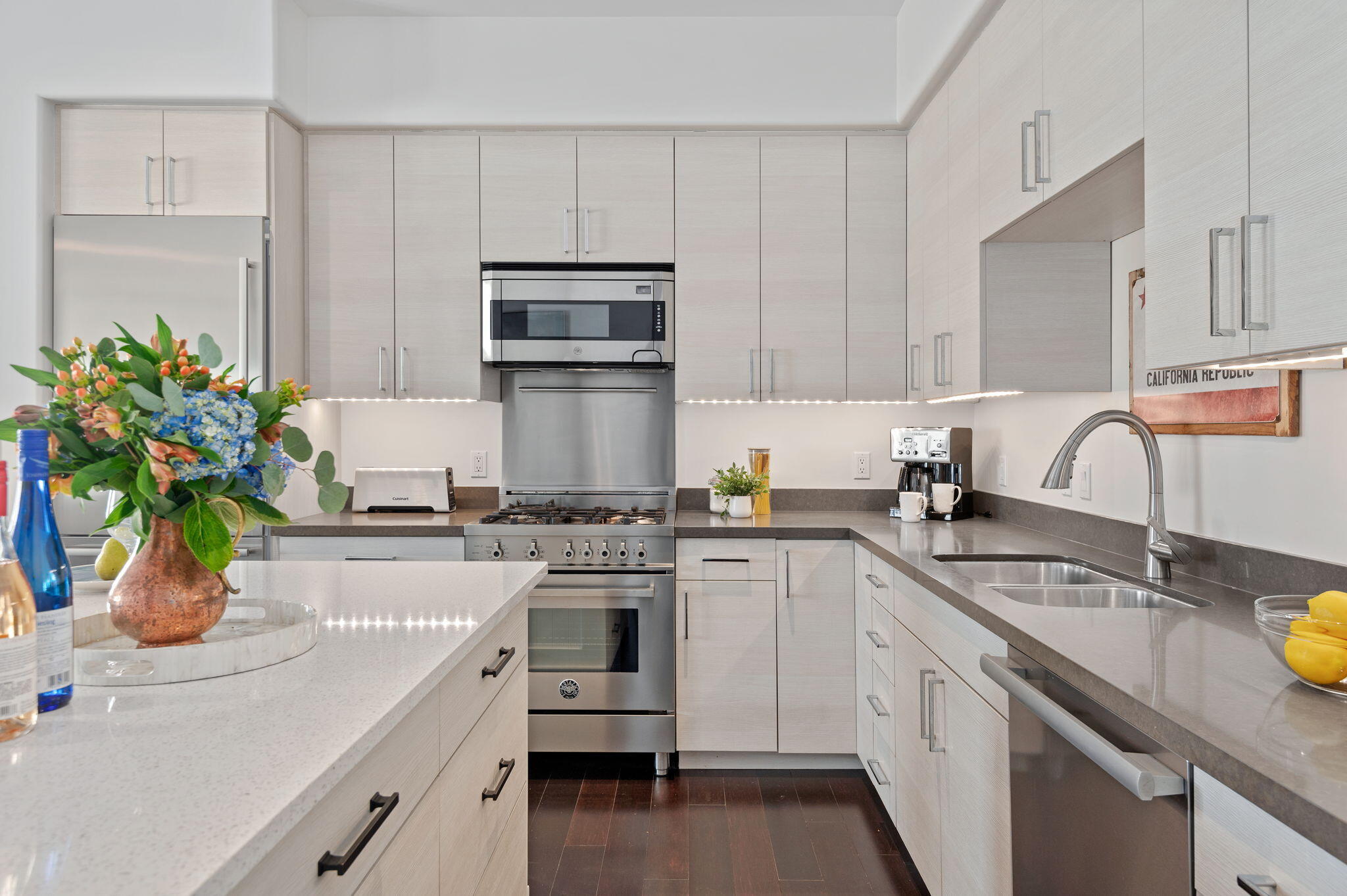 18 West Victoria Street, Unit 303 Santa Barbara, CA 93101 - Photo 4 of 42 a kitchen with white cabinets and appliances