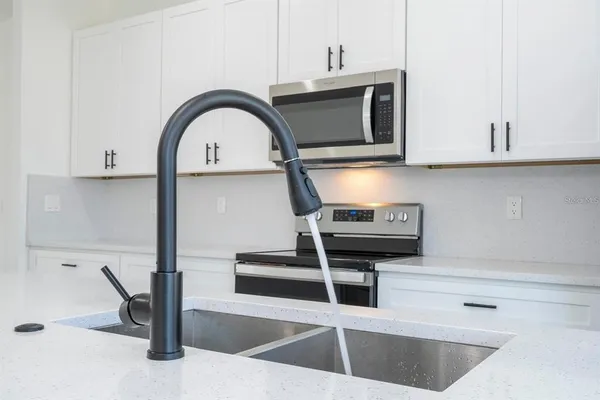 a kitchen with a stove and a microwave