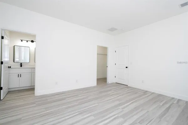 a view of a room with wooden floor