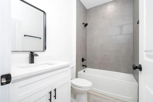 a bathroom with a sink a toilet and a bathtub