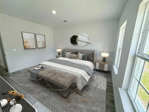 a bedroom with a bed and a large mirror next to a window