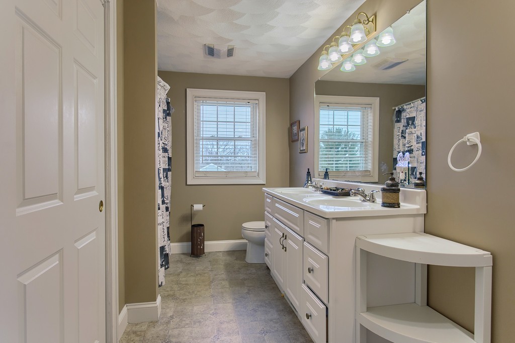 918 Boston Road Billerica, MA 01821 - Photo 11 of 16 a spacious bathroom with a granite countertop sink and a mirror