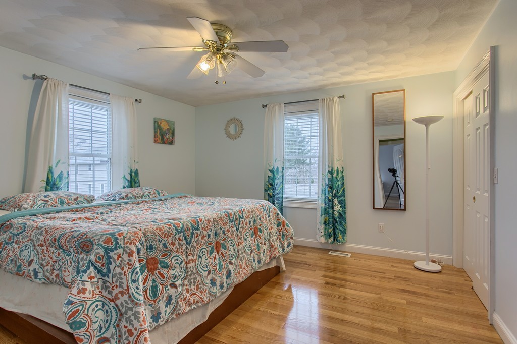 918 Boston Road Billerica, MA 01821 - Photo 12 of 16 a bedroom with a bed and a chandelier