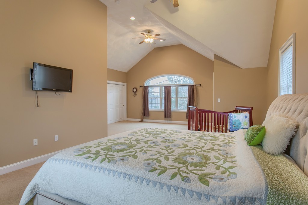 918 Boston Road Billerica, MA 01821 - Photo 10 of 16 a large bedroom with a bed and a flat screen tv