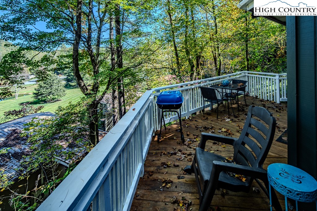 111 Skyview Lane Banner Elk, NC 28604 - Photo 12 of 31 a view of deck with wooden floor and outdoor seating