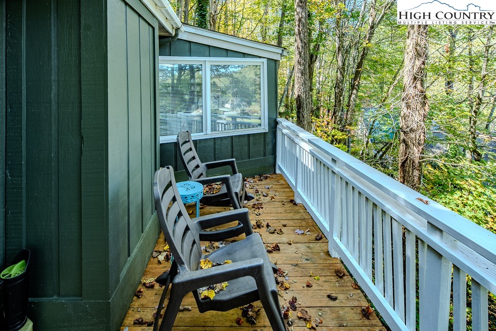 111 Skyview Lane Banner Elk, NC 28604 - Photo 15 of 31 a view of balcony with wooden floor and outdoor seating