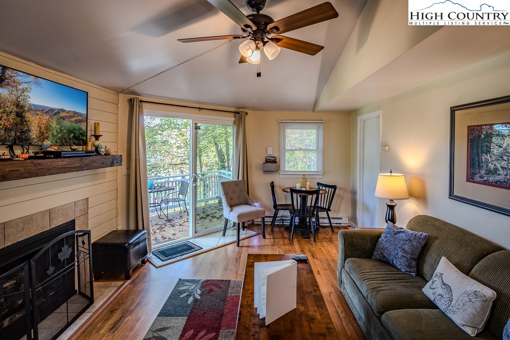 111 Skyview Lane Banner Elk, NC 28604 - Photo 19 of 31 a living room with furniture fireplace and a flat screen tv