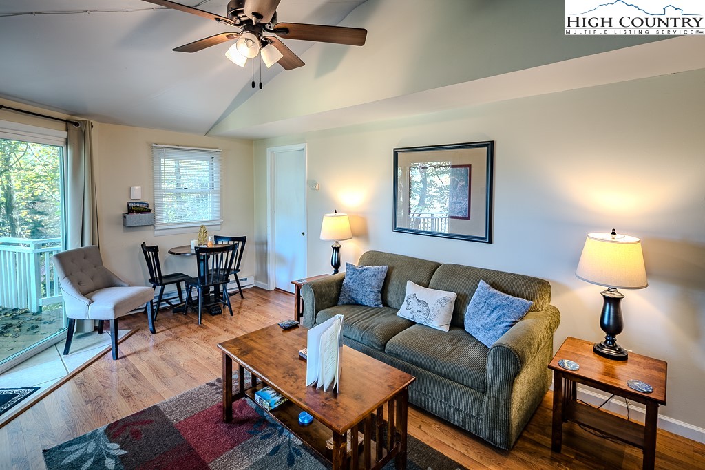 111 Skyview Lane Banner Elk, NC 28604 - Photo 20 of 31 a living room with furniture and a lamp