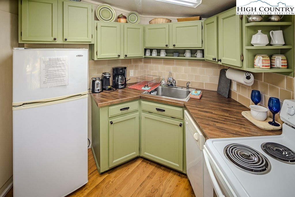 111 Skyview Lane Banner Elk, NC 28604 - Photo 24 of 31 a kitchen with a refrigerator and a sink