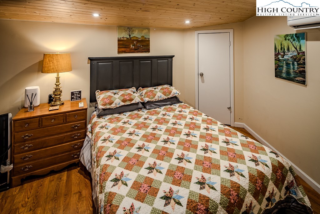 111 Skyview Lane Banner Elk, NC 28604 - Photo 28 of 31 a bed sitting in a bedroom next to a lamp and a lamp