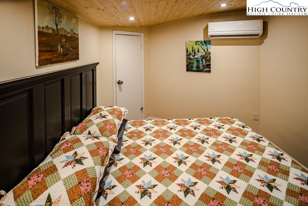 111 Skyview Lane Banner Elk, NC 28604 - Photo 30 of 31 a bedroom with a bed and a window