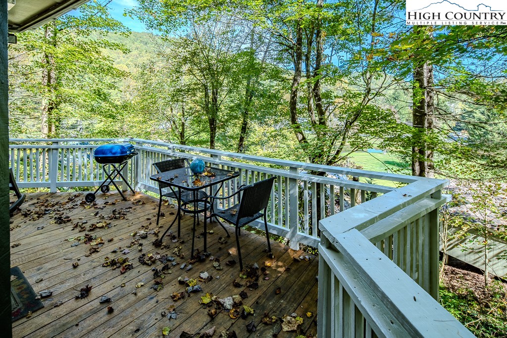 111 Skyview Lane Banner Elk, NC 28604 - Photo 9 of 31 a view of balcony with furniture and umbrella