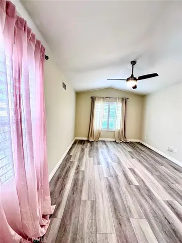 a view of a room with wooden floor and window