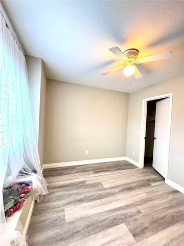 a view of a room with a window and ceiling fan