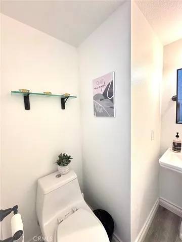 a white toilet sitting next to a bathroom sink