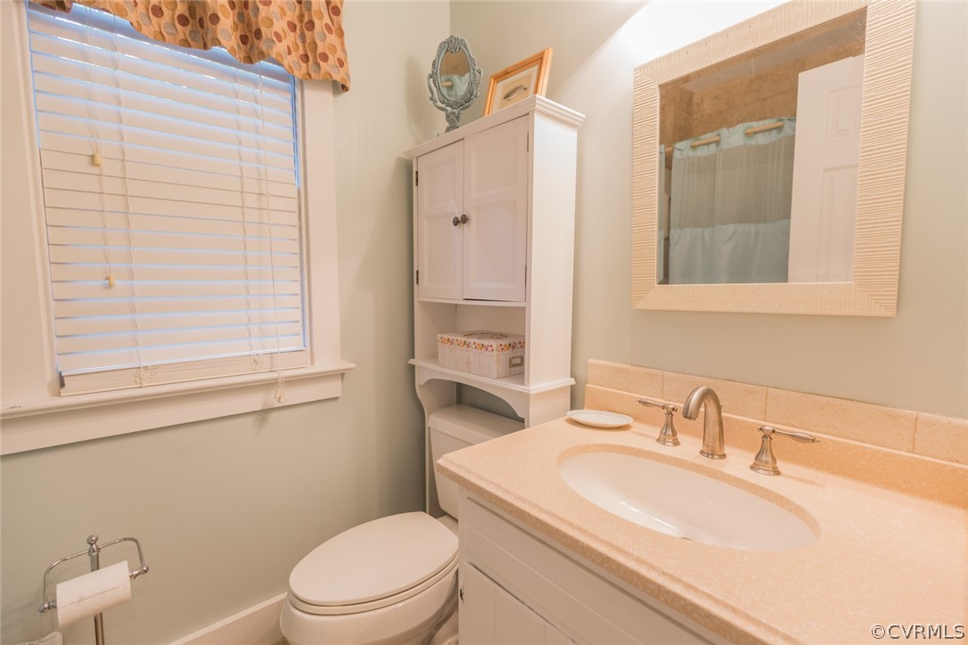 10319 Natural Bridge Road Chesterfield, VA 23236 - Photo 21 of 25 a bathroom with a sink a toilet and a mirror