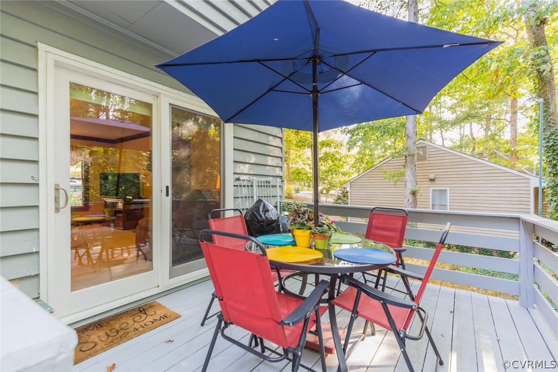 10319 Natural Bridge Road Chesterfield, VA 23236 - Photo 22 of 25 a view of an outside dining space with a table and chairs under an umbrella